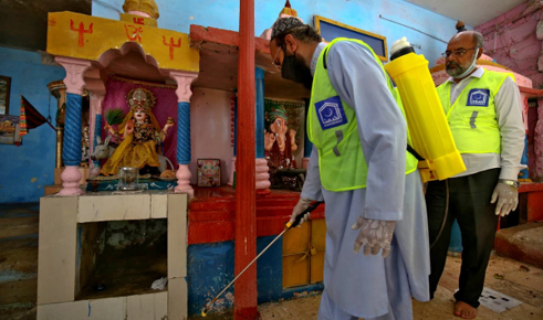 Alkhidmat volunteers sanitizing a Hindu temple